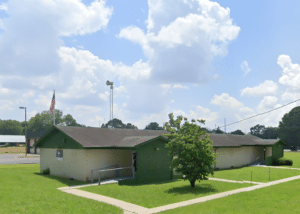 Side view of New Market Clinic and tree off Winchester Rd in Huntsville.